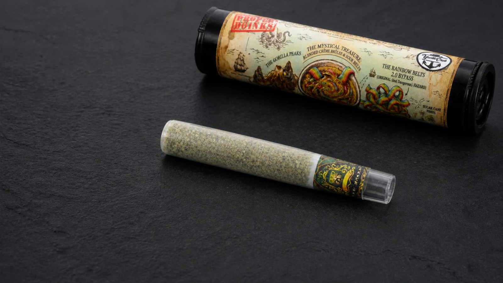 Branded pre-roll lying beside its illustrated tube on dark slate